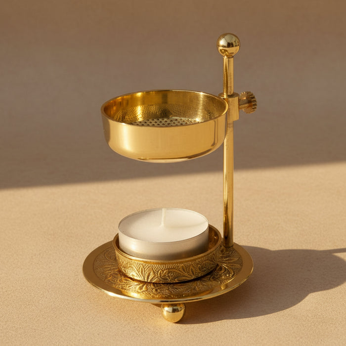 Brass candle holder with a white candle on a white background