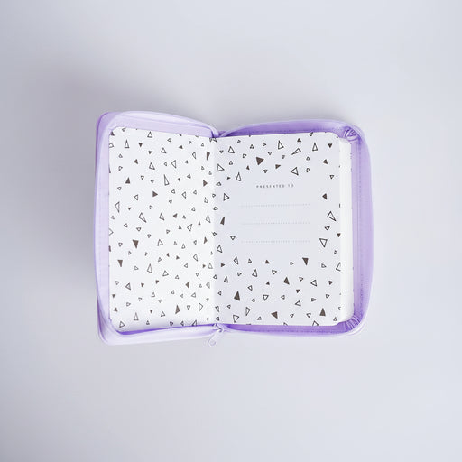 A square zippered pouch with a lavender purple border, shown open to reveal a white interior lined with small black geometric triangle patterns. The center of the lining features a dotted circle and the words 'PRESENTED TO'.