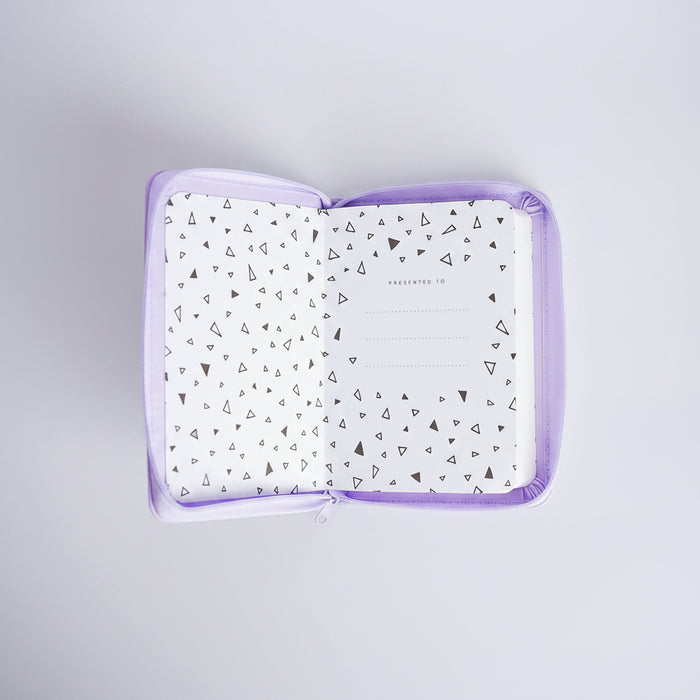 A square zippered pouch with a lavender purple border, shown open to reveal a white interior lined with small black geometric triangle patterns. The center of the lining features a dotted circle and the words 'PRESENTED TO'.