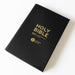 A black Holy Bible with gold lettering, showing the NIV (New International Version) and Larger Print editions, photographed on a clean white background.