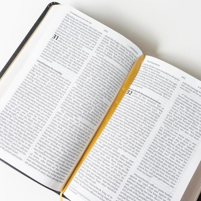 NIV leather open Bible with white pages, black text, a black spine edge, and a yellow page marker.