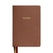 Brown leather Bible with embossed design and 'Holy Bible' text on a white background