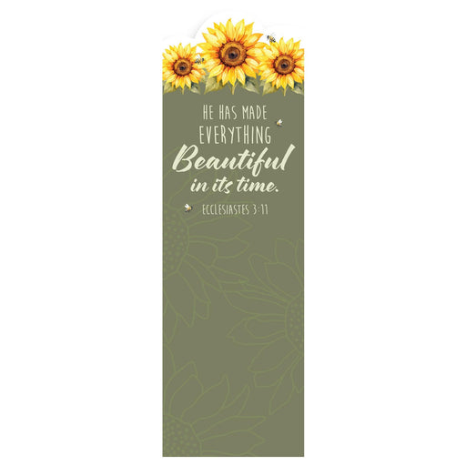 A tall, narrow decorative card or print with a sage green background, featuring three yellow sunflowers at the top and the quote 'HE HAS MADE EVERYTHING Beautiful in its time. ECCLESIASTES 3:11' in white text.
