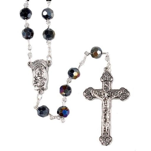 Rosary with black beads and silver cross on a white background