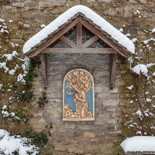 Decorative wall plaque with religious scene featuring a woman, child, and angels on a blue background.