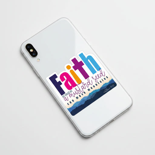 A die-cut sticker featuring the word 'Faith' in large, colorful letters (navy, pink, orange, purple, and blue) above the phrase 'as small as a mustard seed can move mountains' and the Bible verse 'matthew 17:20'. The bottom of the sticker has a layered blue mountain design on a white background.