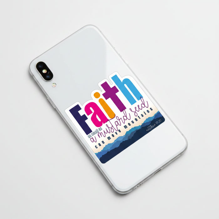 A die-cut sticker featuring the word 'Faith' in large, colorful letters (navy, pink, orange, purple, and blue) above the phrase 'as small as a mustard seed can move mountains' and the Bible verse 'matthew 17:20'. The bottom of the sticker has a layered blue mountain design on a white background.