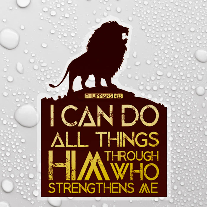 A rectangular decal or sticker with a dark brown background featuring a lion silhouette at the top and the Bible verse Philippians 4:13 in gold lettering. The sticker is shown against a white background with water droplets.