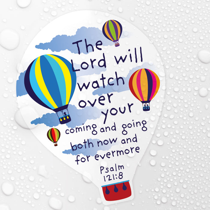 A die-cut sticker shaped like a light bulb, featuring the Bible verse Psalm 121:8 ('The Lord will watch over your coming and going both now and for evermore') in dark blue lettering, decorated with colorful hot air balloons and blue clouds on a white background. The sticker is shown against a white background with water droplets.
