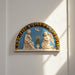 Decorative plaque with religious figures and floral elements on a white background