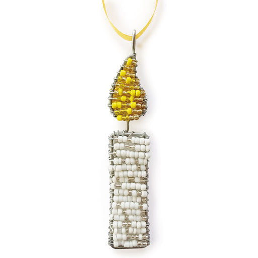 A handmade beaded candle ornament featuring a white beaded candle body and a yellow beaded flame on a silver wire frame, hanging from a yellow ribbon against a white background.