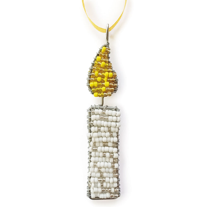 A handmade beaded candle ornament featuring a white beaded candle body and a yellow beaded flame on a silver wire frame, hanging from a yellow ribbon against a white background.