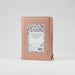 A rose gold leather-bound Bible with a terrazzo-patterned paper insert on the back cover, photographed against a clean white background.