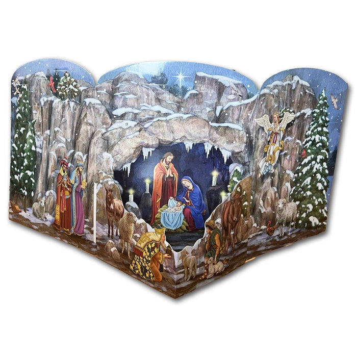Hand-painted wooden Nativity scene backdrop with a snowy mountain cave setting, featuring Mary, Joseph, baby Jesus, angels, wise men, and shepherds.