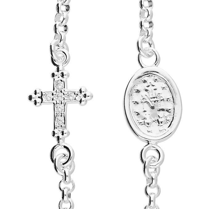 Silver necklace with cross pendant and circular pendant on a white background