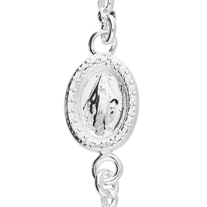 Silver pendant with intricate design on a white background